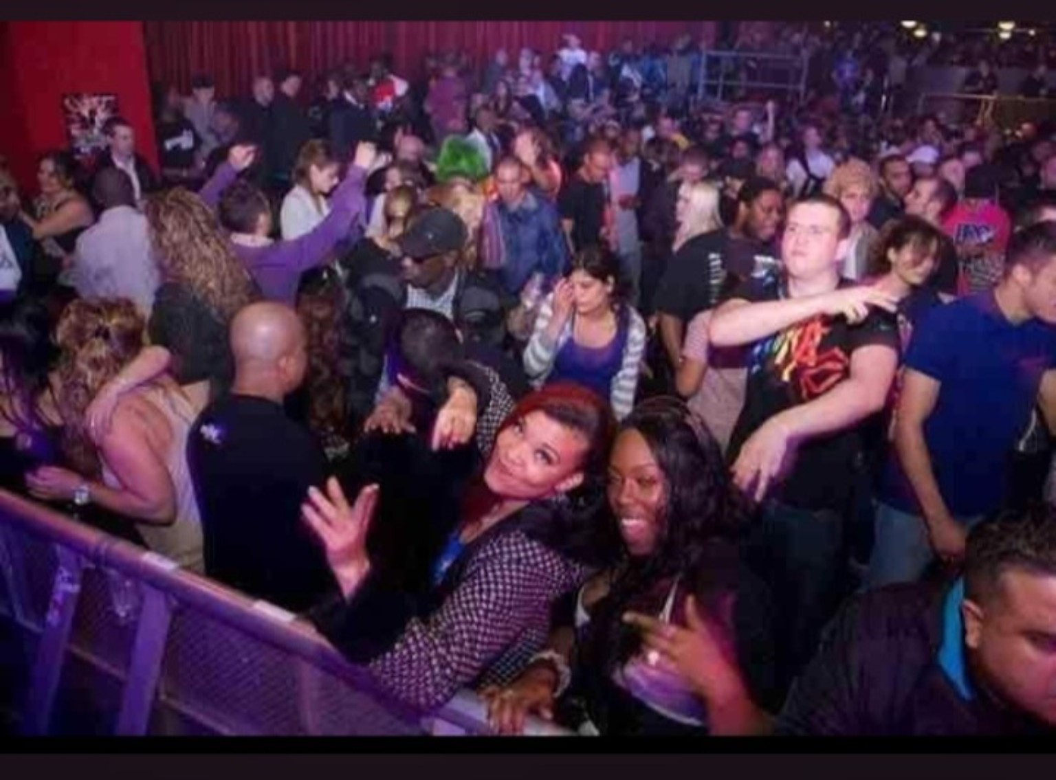 Ravers sharing a moment on a packed dancefloor