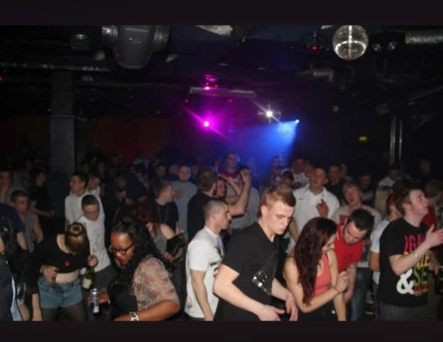 Crowd dancing under club lights